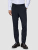 A person wearing a white button-down shirt, Motion Suit Pants Slim Midnight Blue, and dark leather loafers.