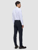 A man seen from behind wearing a white button-down shirt, Motion Suit Pants Slim Midnight Blue, and dark loafers.