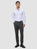 A man wearing a white button-down shirt, Motion Suit Pants Slim Pepper Grey, and black loafers.