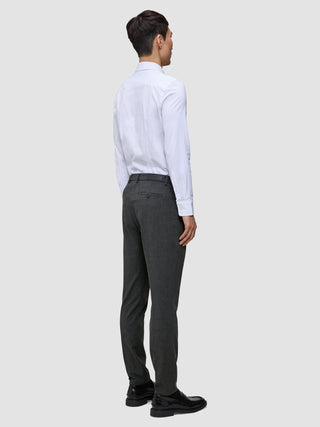 A man viewed from the back wearing a white button-down shirt and Motion Suit Pants Slim Pepper Grey with 360° stretch.