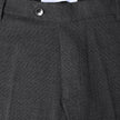 Close-up of the waistband and top of dark grey Motion Suit Pants Slim Pepper Grey, featuring a single button closure, 360° stretch slim-fit, and an interior brand label reading Shaping New Tomorrow.