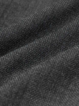 Close-up of Motion Suit Pants Slim Pepper Grey, featuring a grey, textured, knit-like fabric with a 360° stretch.