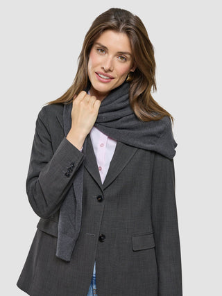 A woman wearing a Women Nara Blazer Cool Brown over a light pink button-down shirt and a grey scarf.