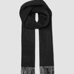 Scarf Black, a black wool scarf with fringed ends, shown looped.