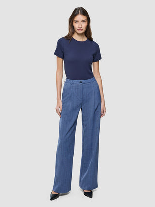 A woman wearing a navy blue t-shirt and Women Serene Pants Wide Ombre Blue Herringbone.