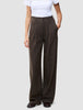 A person wearing Serene Pants Wide Walnut Herringbone in a dark brown pinstripe pattern with a white t-shirt, embodying a minimalist Scandinavian design aesthetic.