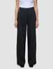 Serene Pants Wide Black featuring high-waisted black wide-leg trousers in a Scandinavian design with front pleats and a button closure.