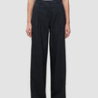 Serene Pants Wide Black featuring high-waisted black wide-leg trousers in a Scandinavian design with front pleats and a button closure.