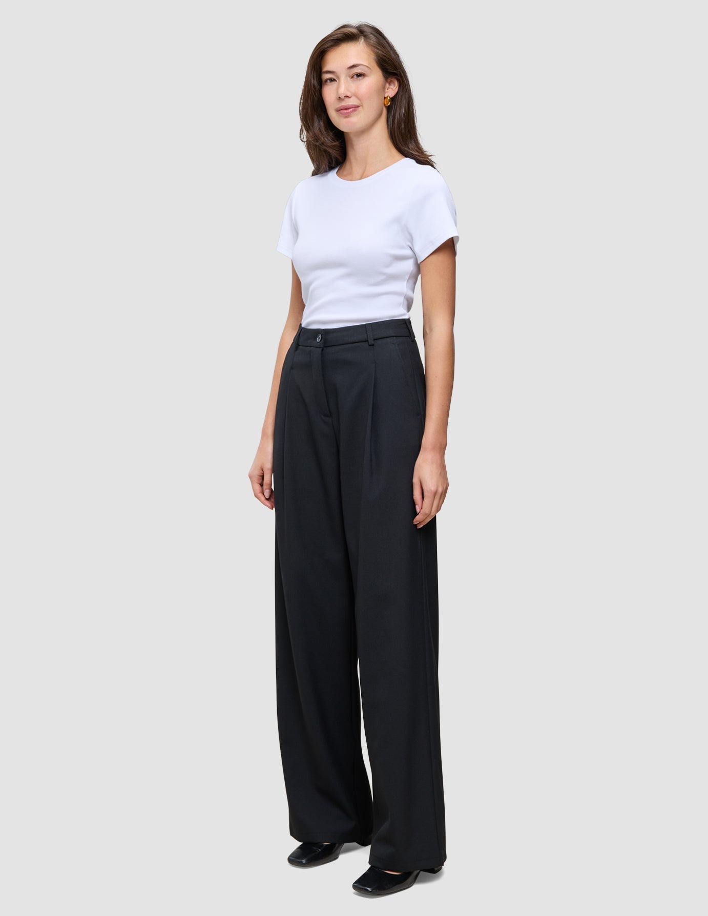 A woman wearing a plain white t-shirt and Serene Pants Wide Black.