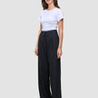 A woman wearing a plain white t-shirt and Serene Pants Wide Black.