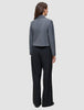 A person seen from behind wearing a grey blazer and black high-waist, wide-leg Serene Pants Wide Black.