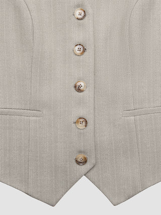 Close-up of a wrinkle-resistant, light beige Women Serene Short Vest Burnt Sugar Herringbone featuring five buttons and two welt pockets.