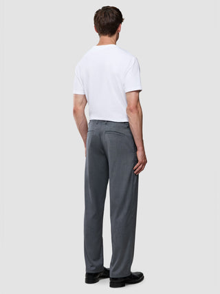 A man seen from behind wearing a white crew-neck t-shirt and Siena Pants Relaxed Fit Herringbone Grey.