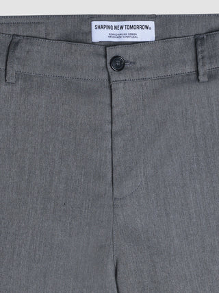 A close-up of grey herringbone Siena Pants Relaxed Fit Herringbone Grey featuring a Shaping New Tomorrow brand label on the waistband.