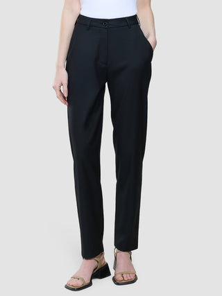 A person wearing Women Skye Pants Tapered Black and tan heeled sandals.