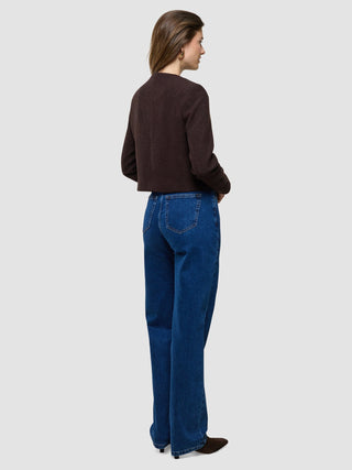 A woman seen from behind wearing a Women Sorae Short Jacket Espresso and blue jeans.