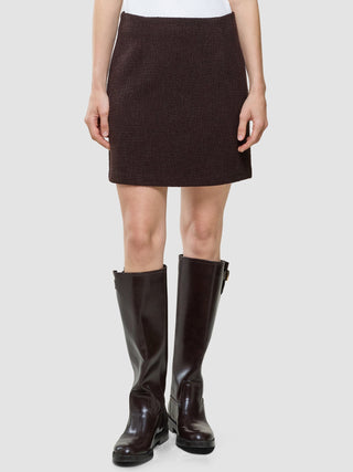A person wearing a Women Sorae Short Skirt Espresso and tall, dark brown knee-high boots.