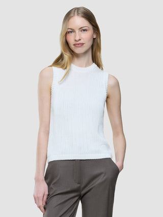 A woman wears a Women’s Structured Knit Top Off White paired with dark trousers.