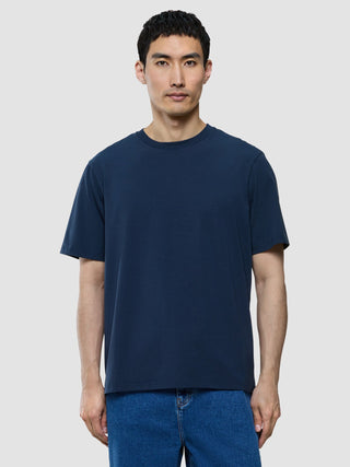 A man wearing a Supima T-shirt Box Fit Navy crew-neck t-shirt featuring 360° stretch.