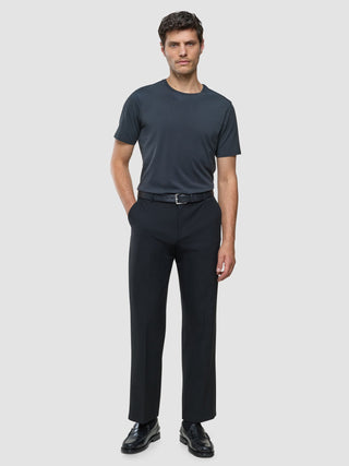 A man wearing a Supima T-shirt Deep Grey, black trousers with a belt, and black loafers.