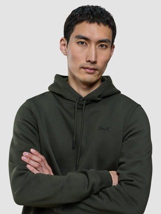 A man with his arms crossed wearing a Sweat Hoodie Green Night.