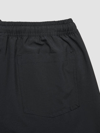 Swim Shorts Black featuring an elasticated waistband, zipper pockets, and a rear patch pocket.