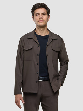 A man wearing a Tech Wool Overshirt Cocoa Brown over a black t-shirt.
