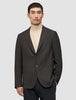 A person wearing a Timeless Wool Blazer Slim Dark Brown Check over a beige turtleneck.