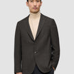 A person wearing a Timeless Wool Blazer Slim Dark Brown Check over a beige turtleneck.