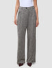 Women Ashryn Pants Wide Domino Herringbone featuring high-waisted, wide-leg trousers in a black and white herringbone bouclé, worn with a white top and dark pointed-toe shoes.