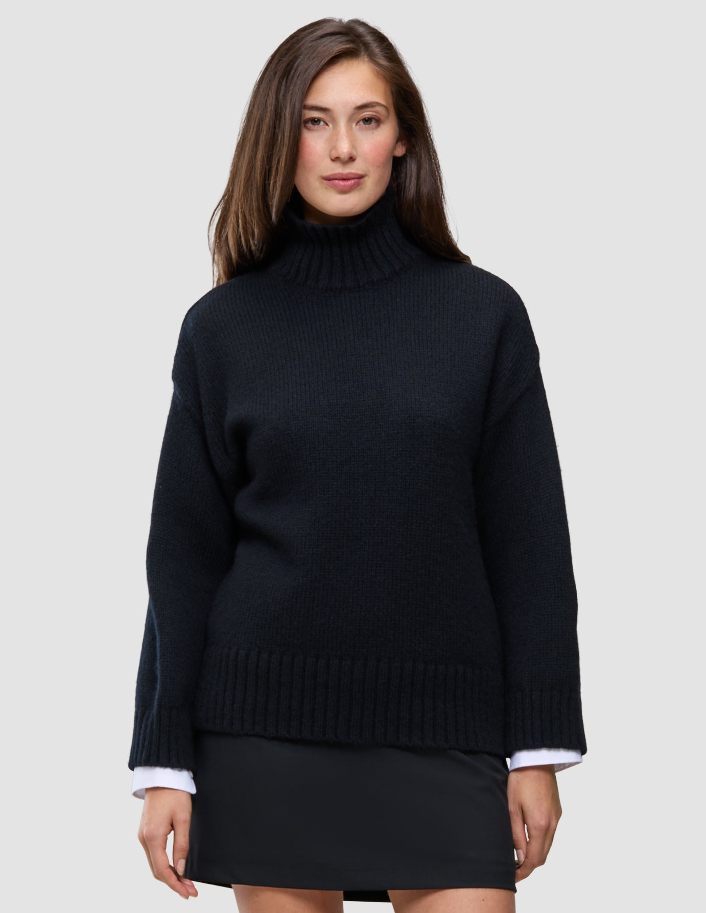 A person wearing a Women Chunky Soft Wool Knit Turtleneck Black in a Scandinavian design.