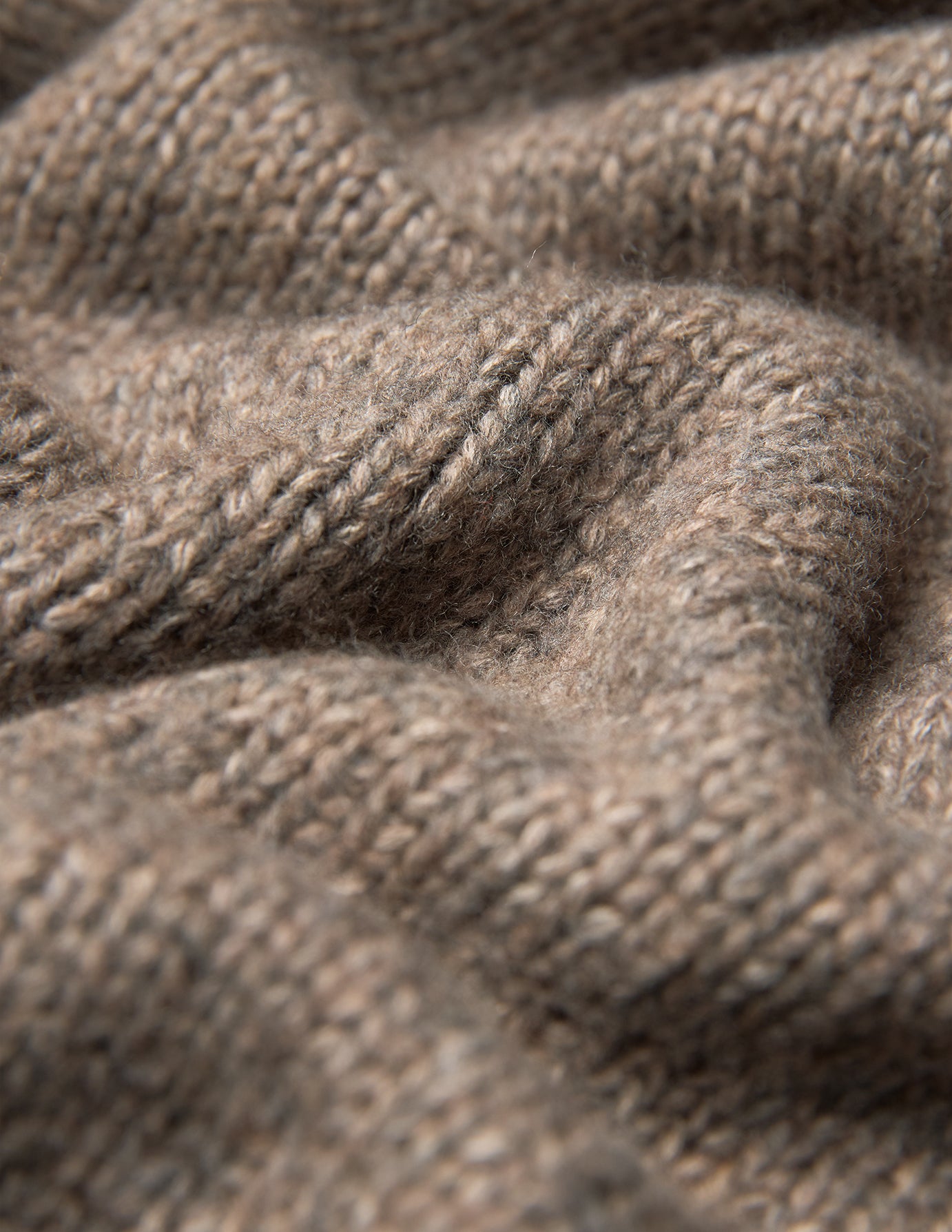 Close-up of a Women Chunky Soft Wool Knit Turtleneck Taupe Melange, featuring a chunky knit turtleneck in a rich, textured taupe merino wool finish.
