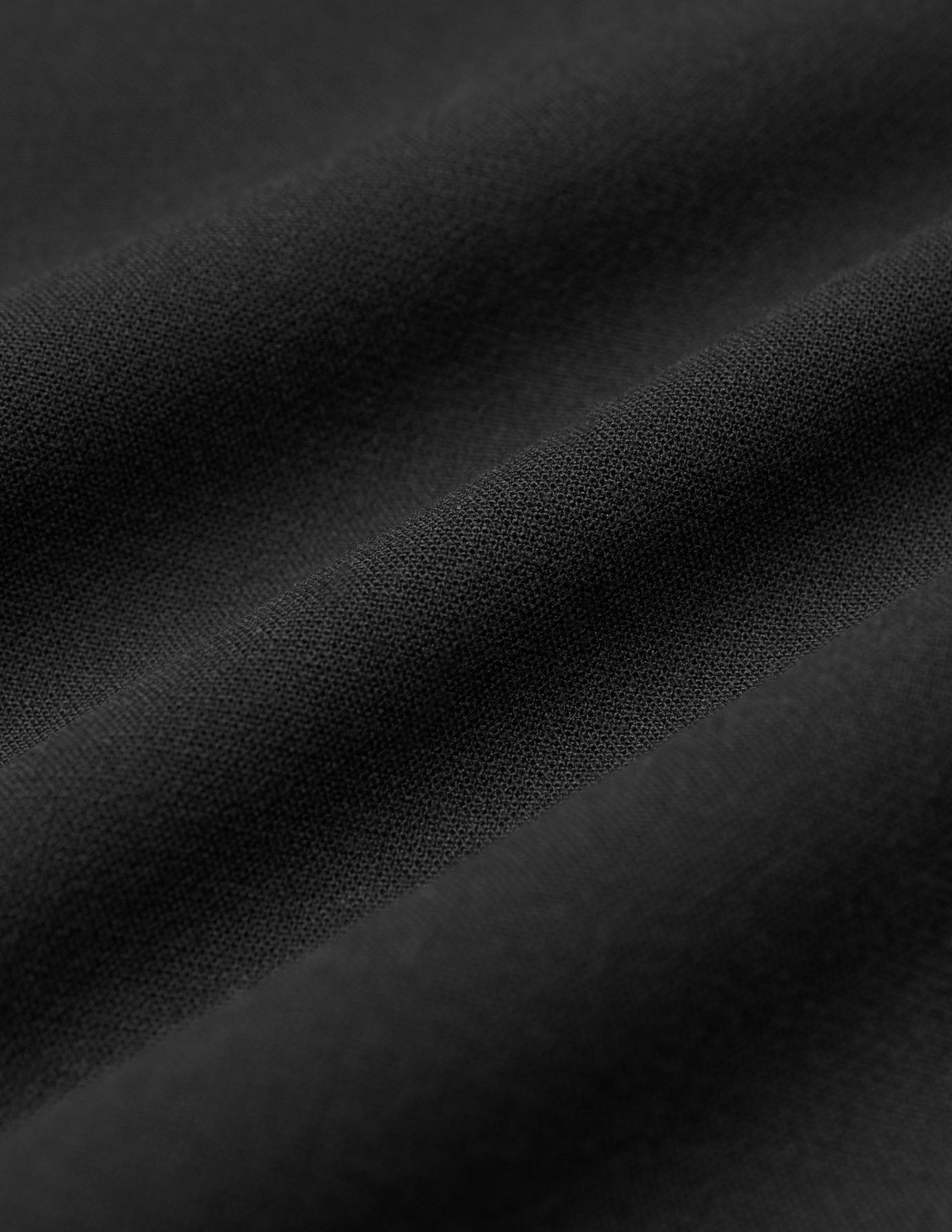 Close-up of the folds in these black Women GO2 Pants Straight Black straight-leg pants.