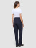 A woman seen from behind wearing a white t-shirt and Women GO2 Pants Straight Blue Nights, which are dark blue high-waisted, straight-leg trousers.