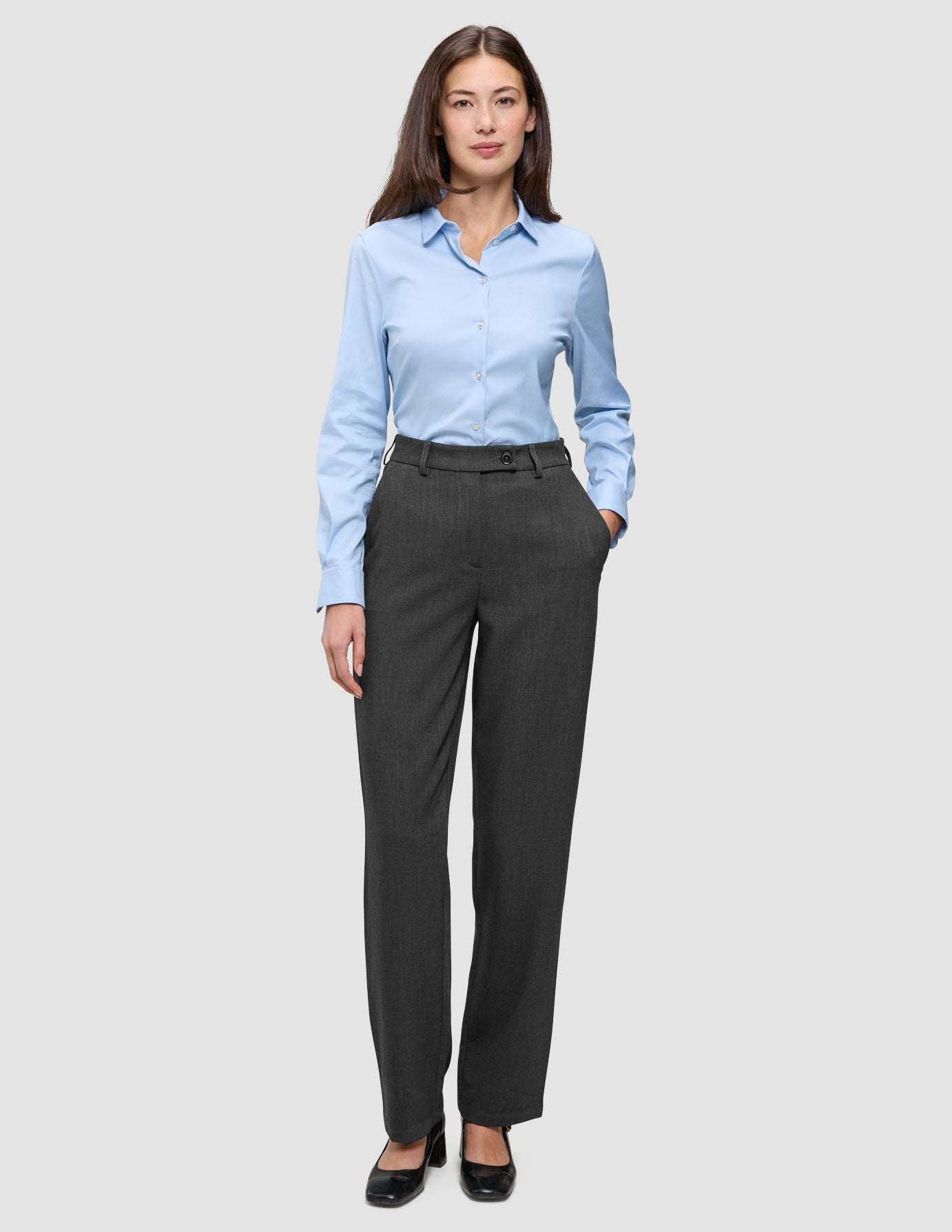 A woman wearing a light blue button-down shirt and Women GO2 Pants Straight Dark Grey Melange.