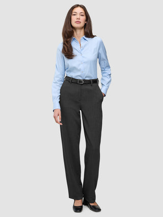 A woman wearing a light blue button-down shirt tucked into Women GO2 Pants Straight Dark Grey Melange with a black belt and black shoes.