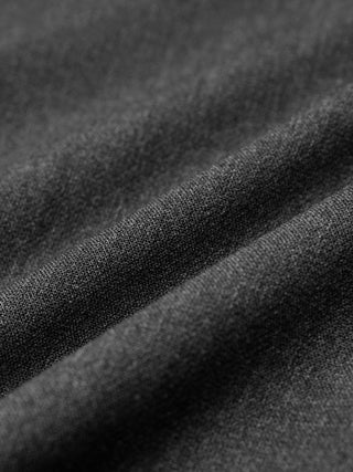 Close-up of Women GO2 Pants Straight Dark Grey Melange, showing draped, dark grey fabric with a visible weave characteristic of Scandinavian design.