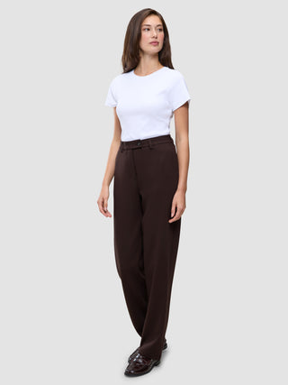 A woman wearing a white t-shirt, Women GO2 Pants Straight Mocha, and loafers.