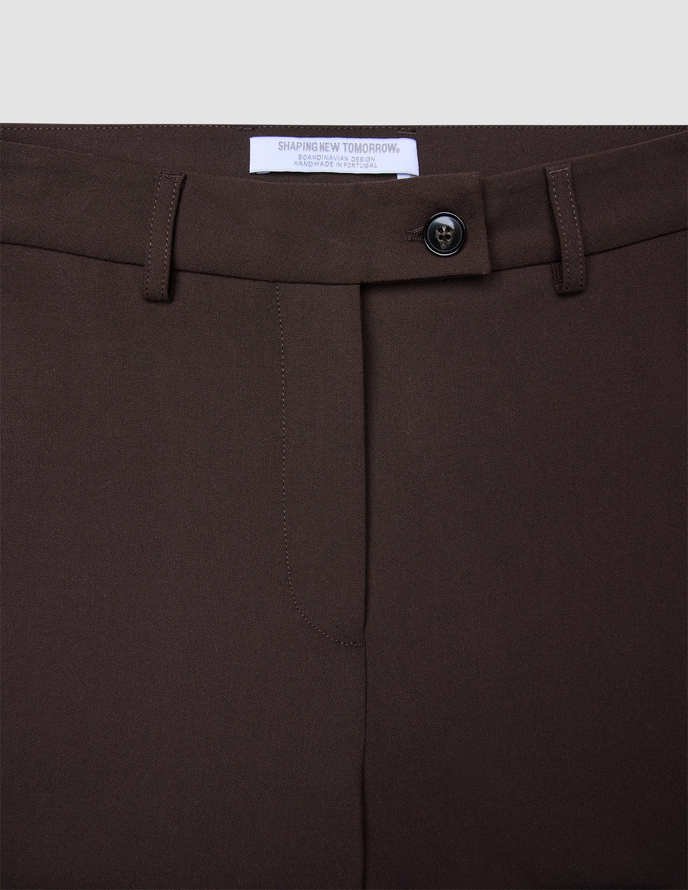 Close-up of the waistband and fly of Women GO2 Pants Straight Mocha, featuring a single button closure and belt loops in a dark brown, Scandinavian-inspired design.