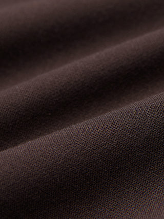 Close-up of brown fabric with a visible knit texture and gentle folds, shown here in Women GO2 Pants Straight Mocha.
