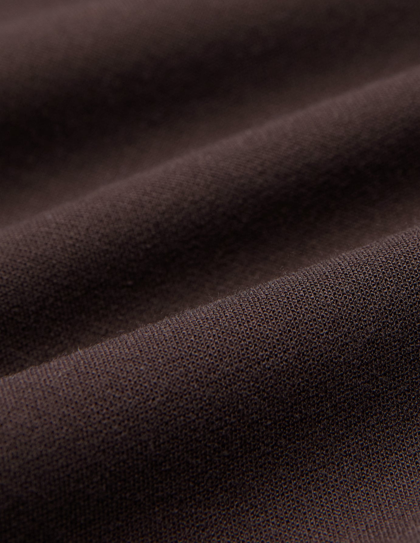 Close-up of brown fabric with a visible knit texture and gentle folds, shown here in Women GO2 Pants Straight Mocha.