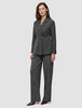 A woman wearing a Women Nara Blazer Fitted Black Check in charcoal gray plaid with matching wide-leg trousers.