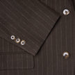 Close-up of a Women Serene Blazer Regular Walnut Herringbone featuring a brown herringbone wool pattern with vertical pinstripes and tortoiseshell buttons on the cuff and front.