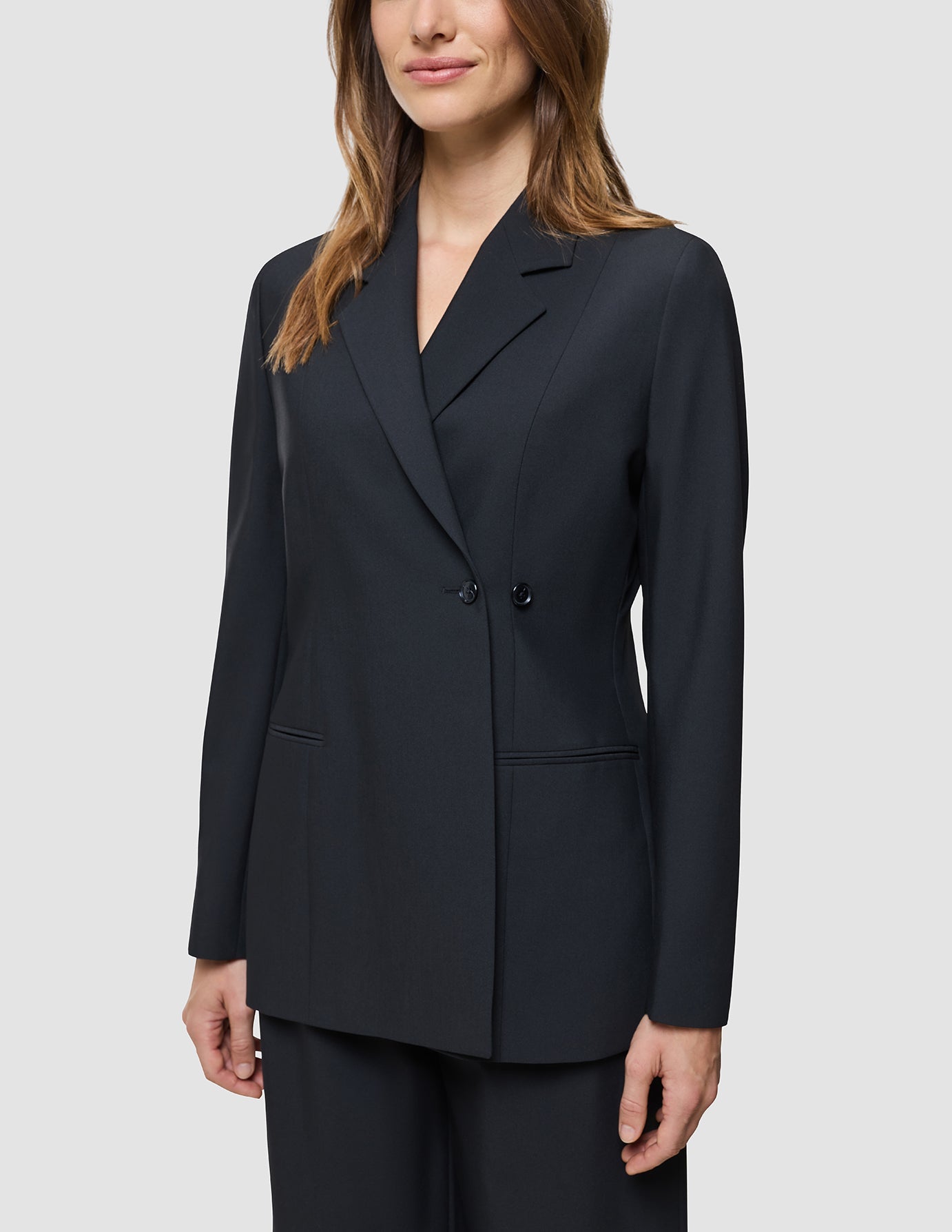 A woman wearing a Women’s Avira Blazer Black.