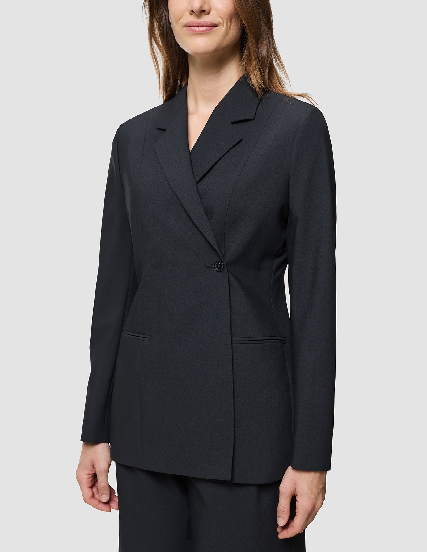 A woman wearing a Women’s Avira Blazer Black.
