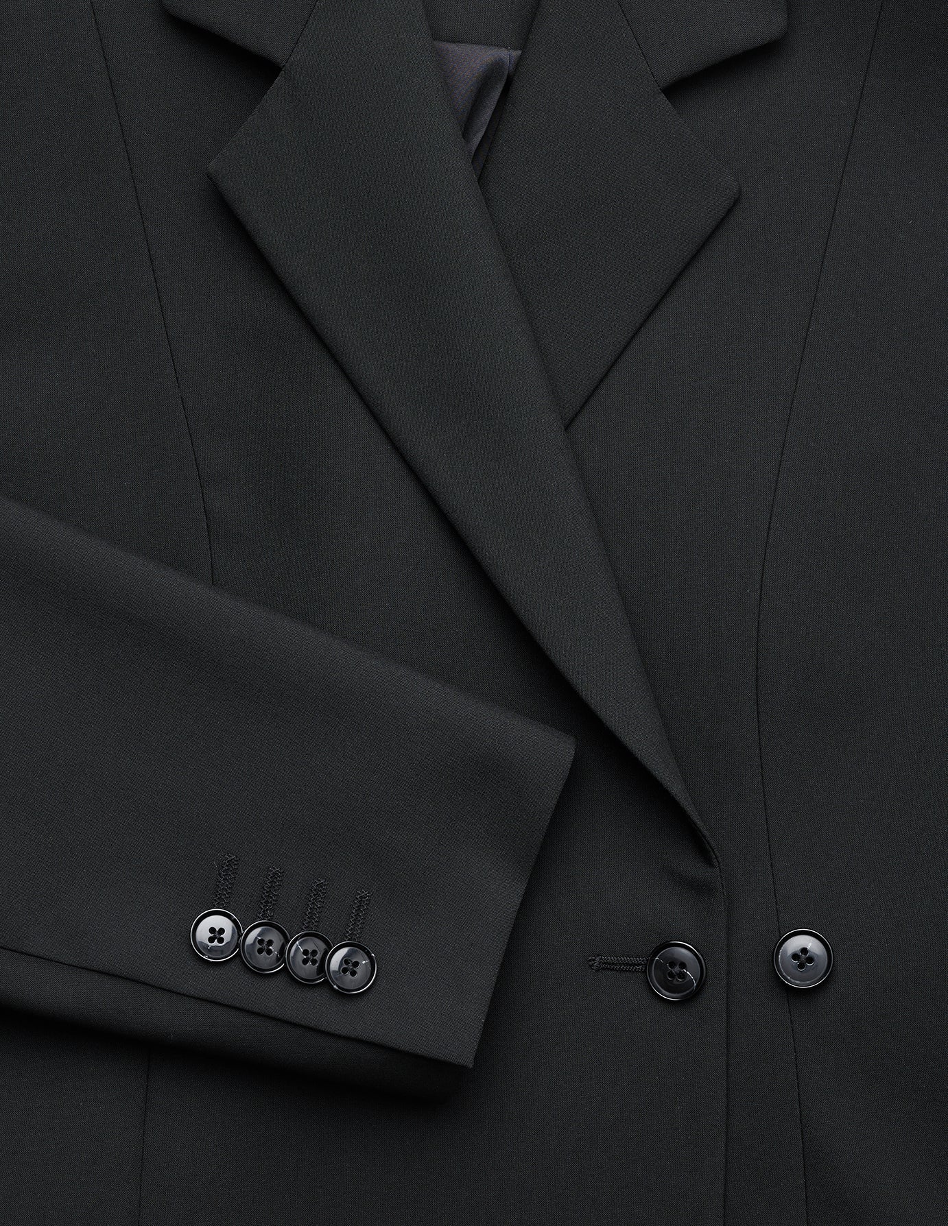 A close-up of a black Women’s Avira Blazer Black, highlighting the lapel and four buttons on the sleeve cuff.