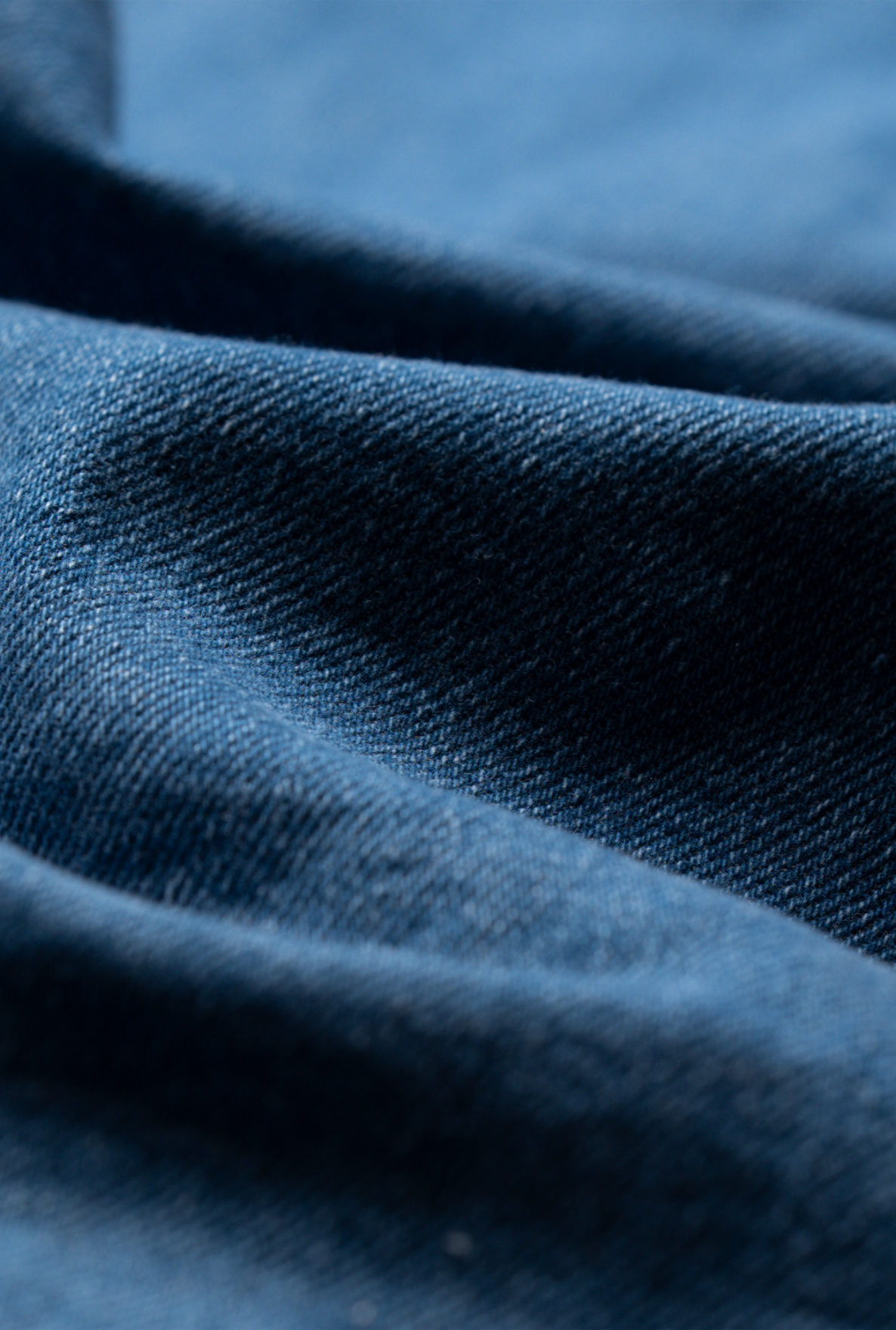Close up material detail showing dark blue jeans