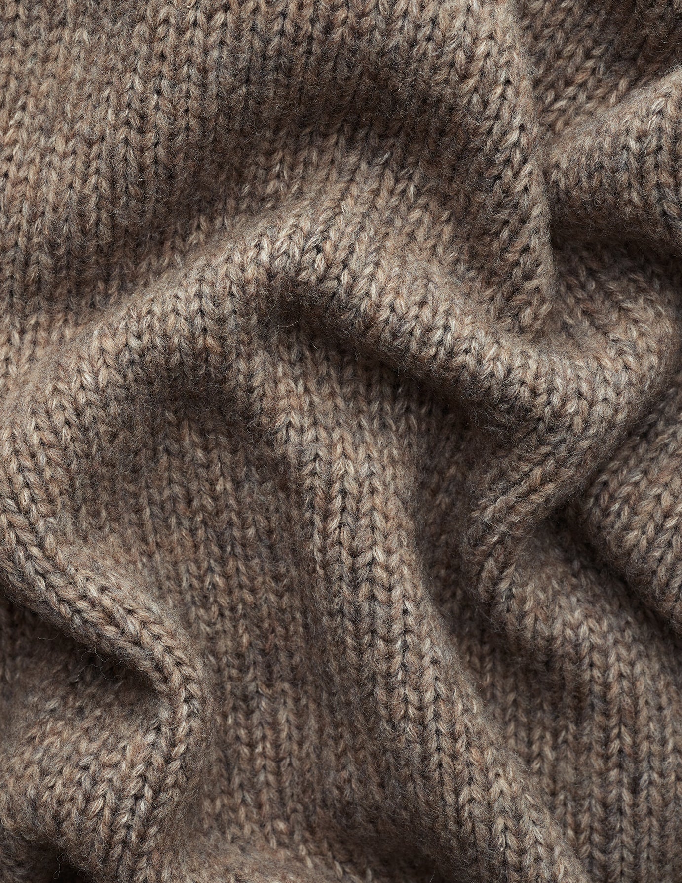 Close-up of a Women’s Chunky Soft Wool Knit Cardigan Taupe Melange, featuring a brown, chunky knit fabric.