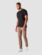 Model in full body wearing a pair of Classic Pants Walnut/Brown with a black t-shirt and white sneakers 