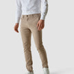 Male model wearing sand/beige pants seen from the front